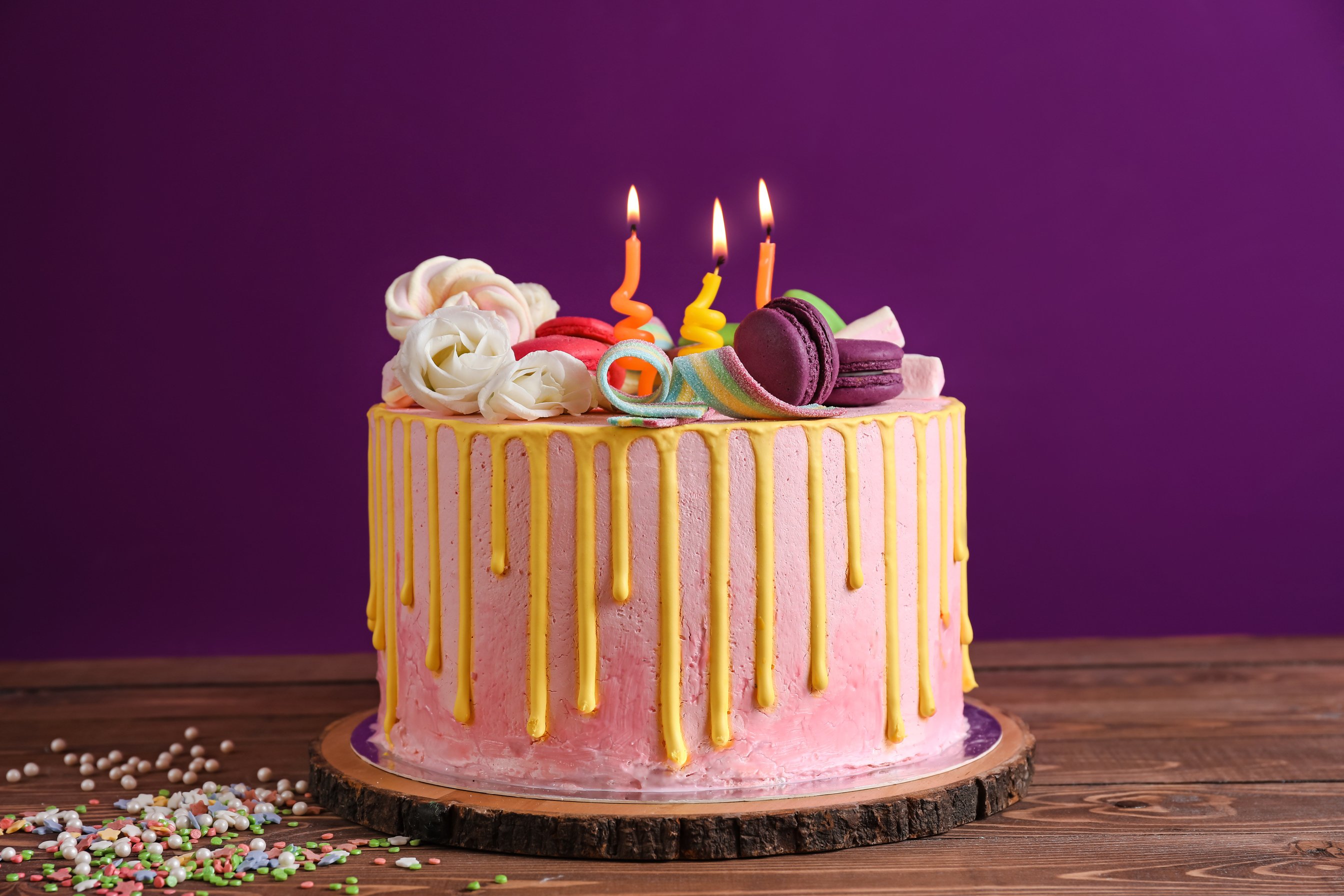 Tasty Cake with Burning Candles on Wooden Table